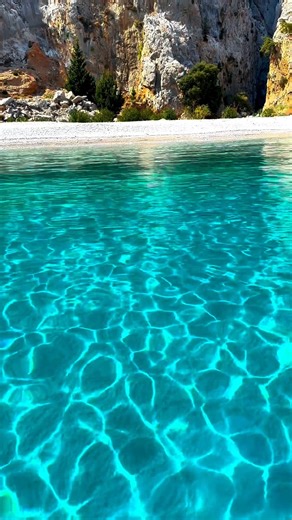 Dive to S E R E N I T Y 🧡 Agios Georgios Dysalonas 💙 📍 St. George Bay, Symi, Greece 🇬🇷 St. George Bay is famous for its dramatic and stunning scenery. It is surrounded by towering cliffs that rise up to 300 meters, creating a breathtaking backdrop for the clear, turquoise waters below. The bay is relatively secluded and less crowded compared to other tourist spots, offering a serene and tranquil environment. It's an ideal location for those looking to escape the hustle and bustle and enjoy 
