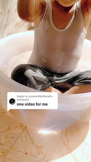 Playful Toddler Splashing in Water Tub