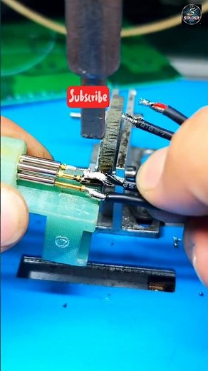 The video displays a process of soldering or similar precision assembly, likely for electronics or