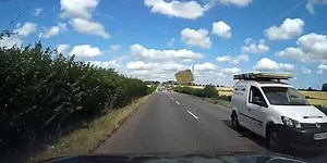 The moment when the wooden plate placed on a car breaks off, and flies into the window of another car (Video)