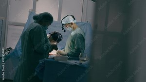 Process of trauma surgical operation professional team medical nurses doctors surgeons perform heart surgery neurosurgery in sterile operating room with equipment modern hospital emergency saving life