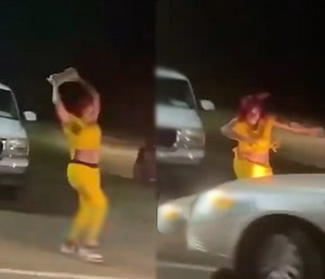 Her Legs Done For: Driver Smashes Chick Between Two Cars After She Tried To Throw A Cinderblock At His Car!