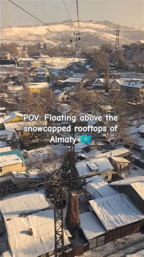 POV: Floating above the snowcapped rooftops of Almaty, Kazakhstan.