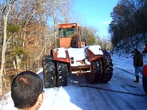Stuck in the snow - International 4366 Tractor Tries to pull a Semi out of the ice