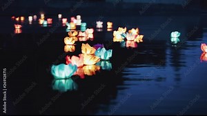 Running water flashlight. The glow of lanterns on the water at night. Romantic evening. Beautiful floating water lanterns.