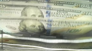 Money counting. Close up currency counting machine counting dollar bills. Machine counter calculates 100 dollars banknotes in slow motion. Closeup currency count machine counting dollar banknotes.