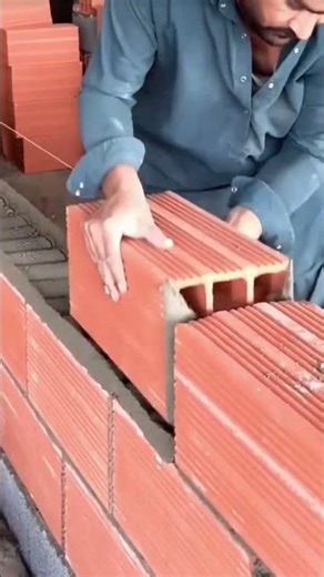 the process of installing large red bricks in cement mortar for building construction #popular