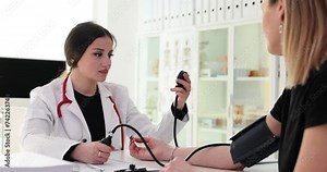 Doctor measuring heart and blood pressure caring for a young patient at medical consultation