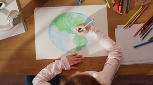 clip-1093149657-top-view-little-girl-drawing-our-beautiful