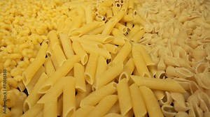 Different types and shapes of dry Italian pasta. Pasta background.