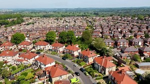 Aerial footage of the British town of Harrogate, a town in North Yorkshire, England, east of the Yorkshire Dales National Park in the summer time showing residential housing estates
