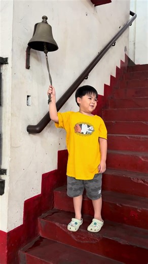 Ringing the bell 🔔 at the Intramuros Fire Station—small hands, big history.