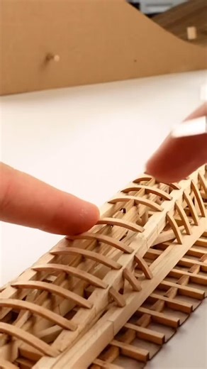 Design & Furniture on Instagram: "Cascade Bridge model by @naato_studio. It’s a connection between a walking path and a Performance Art Center on the North side across the river. A sense of continuity and fluidity in the water environment is suggested through the evolving structure created from the repetition of small trusses along the catenary arch. Each truss wraps around the main beams, fusing with the joist and railing like a string. As you move toward the north, the West side expands and cu