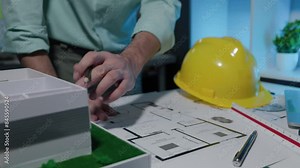 Architects work on new projects with blueprints and models to design what the client wants. Engineer is planning strategies that will maximize customer satisfaction. Stock Video