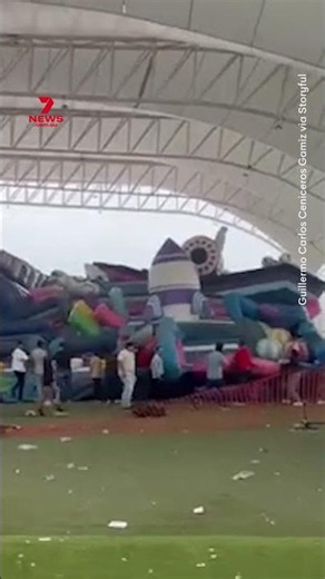 Moment strong winds lift inflatable bouncy castle with children inside