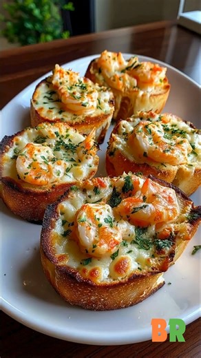 Crabby Shrimp-Stuffed Garlic Bread Bombs 🦐🧄 Golden garlic bread cradles a luxurious filling of shrimp, sweet crab, and molten cheese, emerging from the oven with a rich seaside aroma. Crisp edges give way to a creamy, savory center that feels indulgent yet irresistibly approachable. Ingredients : 1 French baguette, cut into thick slices 1 pound shrimp, peeled, deveined, and cooked 1/2 cup lump crab meat 2 tablespoons olive oil 3 tablespoons unsalted butter, melted 4 cloves garlic, minced 1 1/2