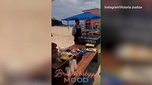 Victoria Justice dances in hot orange summer dress on the beach