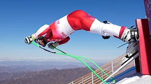 Why does the starting 'beep' in Olympic ski racing finish after the athlete has already left the gate?