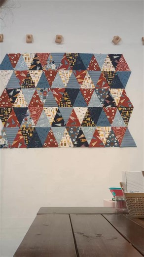 Not all patterns go as planned. My triangles were not matching up and it was going to drive me crazy, so we called an audible. We were already worried that the quilt was going to be too busy with all the different prints, so adding the gold strips fixed both problems! Original pattern: Triangle Time by Riley Blake Designs #stitchedonthefarm #quilting #smallbusiness | Stitched on the Farm