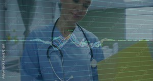 female nurse pausing page and annotating patient data while monitoring waveform in nurse station