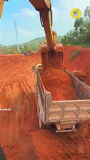 Excavators Load Soil Onto Trucks