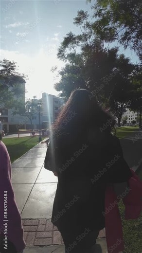 Teen Girls Walking Away Under Palm Trees (Rear View)