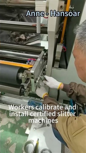 Workers calibrate and install certified slitting machines