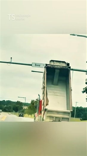 Why do dump trucks drive with their bodies raised?
