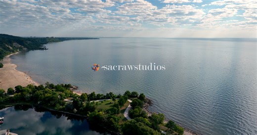 Aerial View of Serene Lake Shoreline with Marina and Sandy Beach