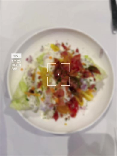 Wedge Salad is a classic, simple salad—especially popular in American steakhouses (you’d totally recognize it 😉). What it is: \t•\tA quarter or half wedge of iceberg lettuce (kept whole, not chopped) \t•\tTopped with creamy dressing, traditionally blue cheese \t•\tFinished with crispy bacon bits \t•\tCherry tomatoes \t•\tSometimes red onion, chives, or extra cheese Why it’s called a “wedge”: Because the iceberg lettuce is cut into thick wedges instead of being chopped. Common variations: \t•\tB