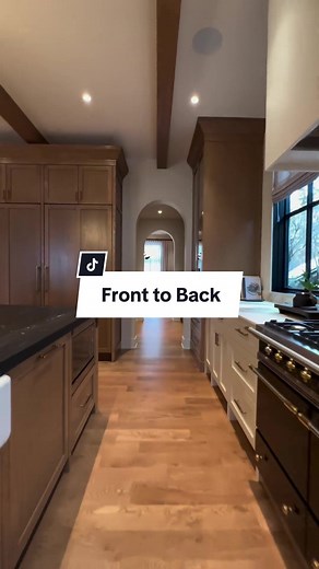 As you transition from the mudroom through this stunning kitchen, the arched openings guide your journey with an inviting elegance. Custom cabinetry lines the way, offering both beauty and practicality, while the marble counters add a touch of timeless luxury. Passing by the butler’s pantry and food pantry, each detail has been carefully crafted to ensure perfection. The journey culminates in the dining room, where these thoughtful designs connect every space seamlessly, making this home truly e