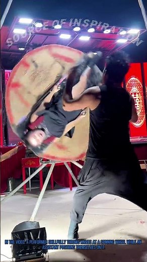 Acrobatic Knife Throwing: Performer’s Precision on Spinning Wheel Leaves Audience in Awe