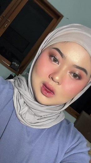 Person in Light Blue Top and White Headscarf