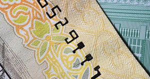 Closeup of US dollar bill serial number and security features