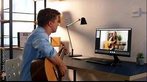 music, e-learning and technology concept - young man or musician with computer learning to play guitar with teacher online at home