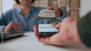Scanning a barcode on a smartphone screen, a small business warehouse worker with a scanner scans a barcode pass, an online payment scanner for a phone, a small business warehouse