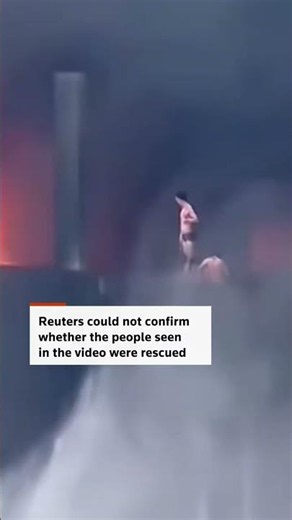 People seen on rooftop as fire rips through shoe factory in China