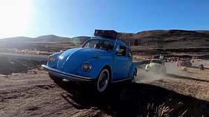 VW Beetle convoy cruises Bolivia's scenic mountains