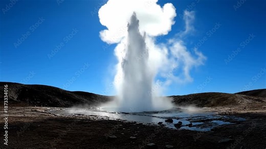 Powerful Geyser Erupts Sending Hot Water and Steam High into the Blue Sky.
