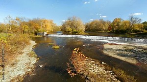Loop features the Big Blue River splashing over an old mill dam on an autumn day in Ediburgh, Indiana.