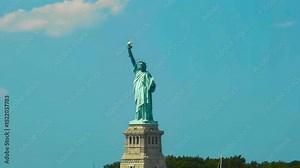 Awesome video timelapse or time lapse animation of the Statue of Liberty falling together in its place and creating dust while boat masts and ships are moving in timelapse mode in the foreground.