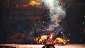 Dramatic shot of a man welding in an old garage, working with steel, close-up of a work place, welding as a hobby