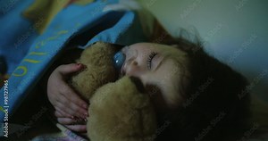 Little girl sleeping hugging her teddy bear