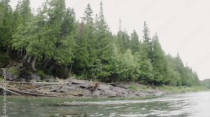 Line and bait flying in slow motion on fly fishing hitting the perfect spot to catch a fish