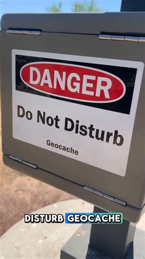 Geocaching on Instagram: "😵‍💫 This geocache really knows how to turn heads. 😵‍💫 Rate this cache from 1-10 in the comments. 🏆 Reel by justhike. Video: A geocacher approaches a metal box secured to a lamp post, with a label that reads “danger, do not disturb”. They point out the hinges on all sides, showing the side, top, and bottom of the box. They then turn the box counterclockwise and open the door attached by hinges from the bottom of the box, lifting it up. The geocache container is insi