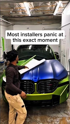 Lime green vinyl wrap going down on this BMW hood