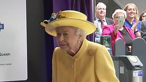 Following some concerns about the monarch's mobility, the Queen walks happily around the station concourse, with the aid of a stick.