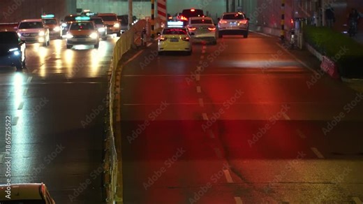 This dynamic night timelapse video captures the electrifying hustle of a city’s peak-hour traffic and crowd flow, with vivid car light trails streaking through bustling urban intersections under glowi