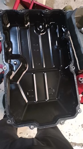 Inspecting a Black Plastic Fuel Tank Cover in Detail