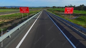 Wrong way go back road signage on major high speed highway (freeway) (motorway) exit or off ramp turning. Life journey bad choices